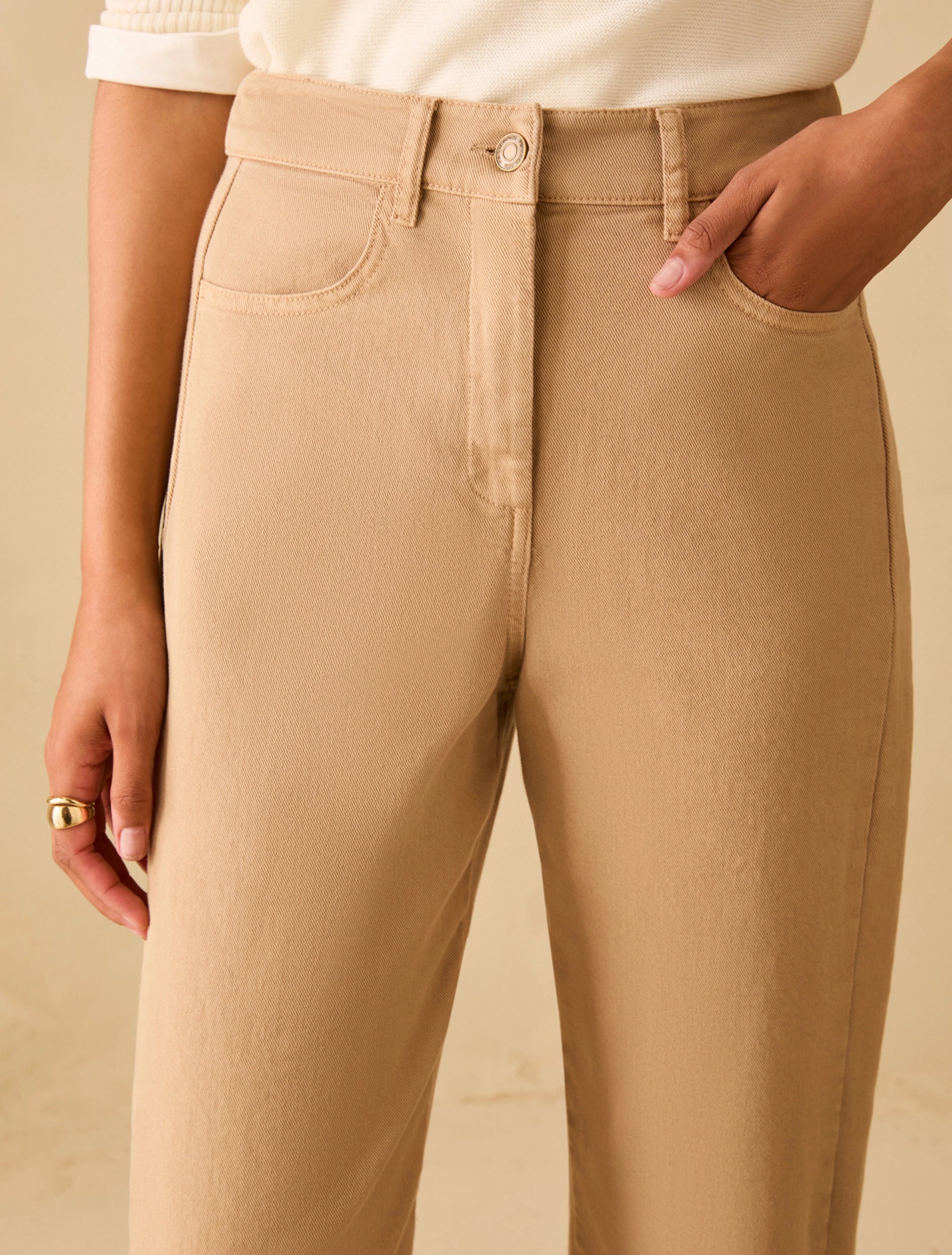 Mid rise cotton denim trousers close up waistband and button detail