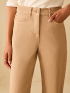 Mid rise cotton denim trousers close up waistband and button detail