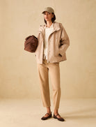 Straight leg camel denim trousers styled with jacket and cap