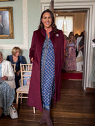     Pennyblack Corsaro burgundy long tailored coat styled over printed midi dress