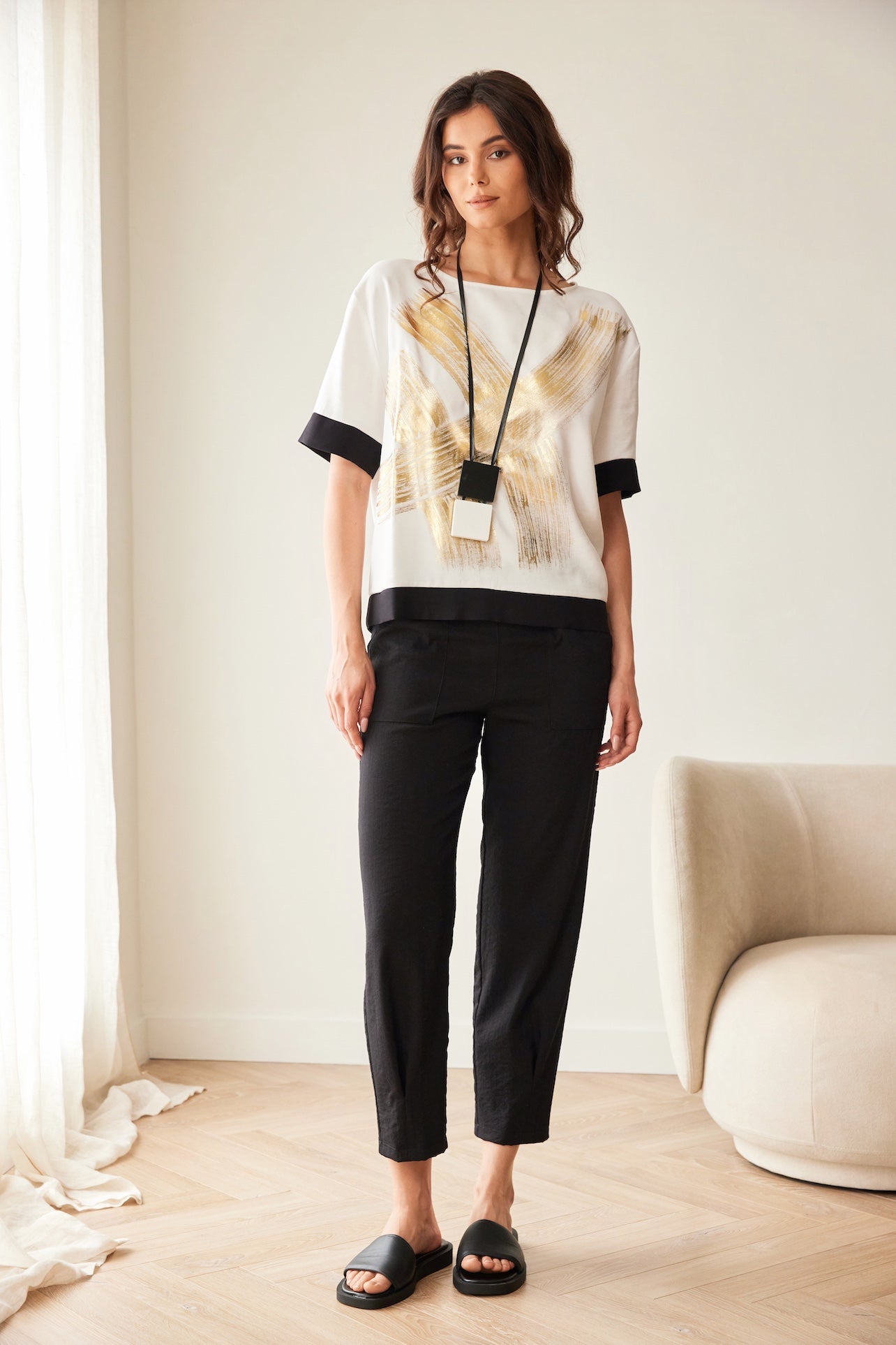 Peruzzi Metallic Brush Stroke Print Top styled with black trousers full length view