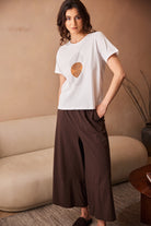 Peruzzi Circle Line Graphic Print Top modelled with brown trousers in lifestyle setting