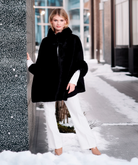 Pia Rossini Ariana black faux suede winter cape with faux fur trim on model