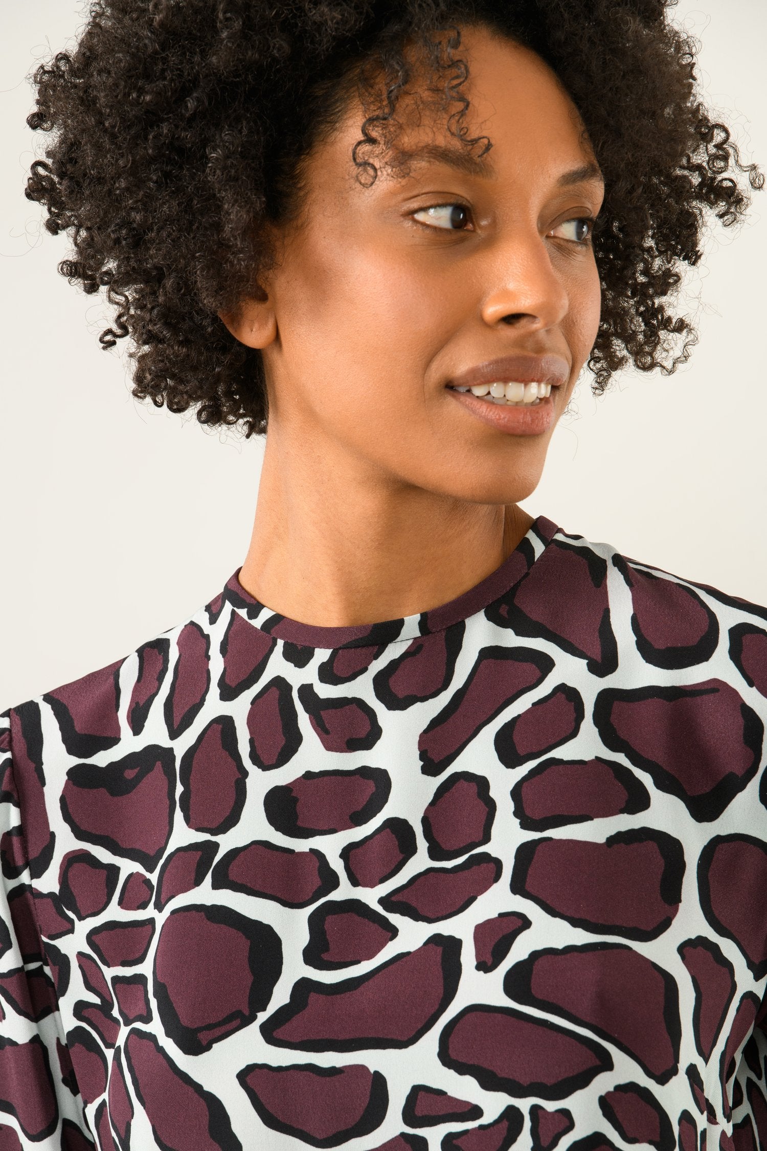 Close-up of animal print fabric and silky texture on Chantel blouse