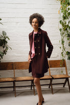 Smiling model wearing Sisters Havana wine mini skirt and pink satin blouse, styled for occasionwear