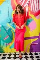 Sisters Java red lace bow blouse styled with pink midi skirt