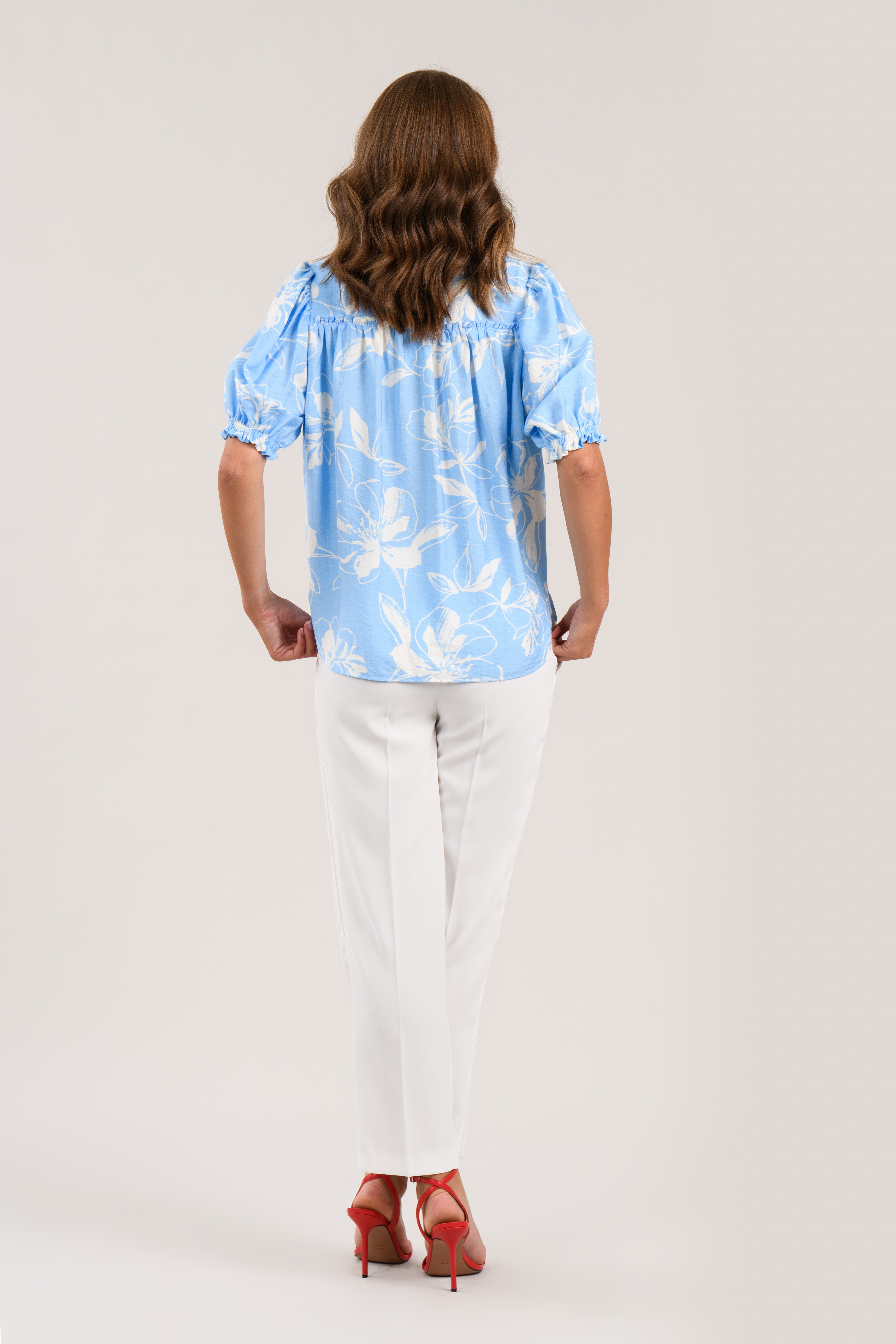 Sisters Jet floral blouse back view in blue with short puff sleeves
