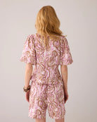 Back view of Summum pink print blouse and shorts set with puff sleeves