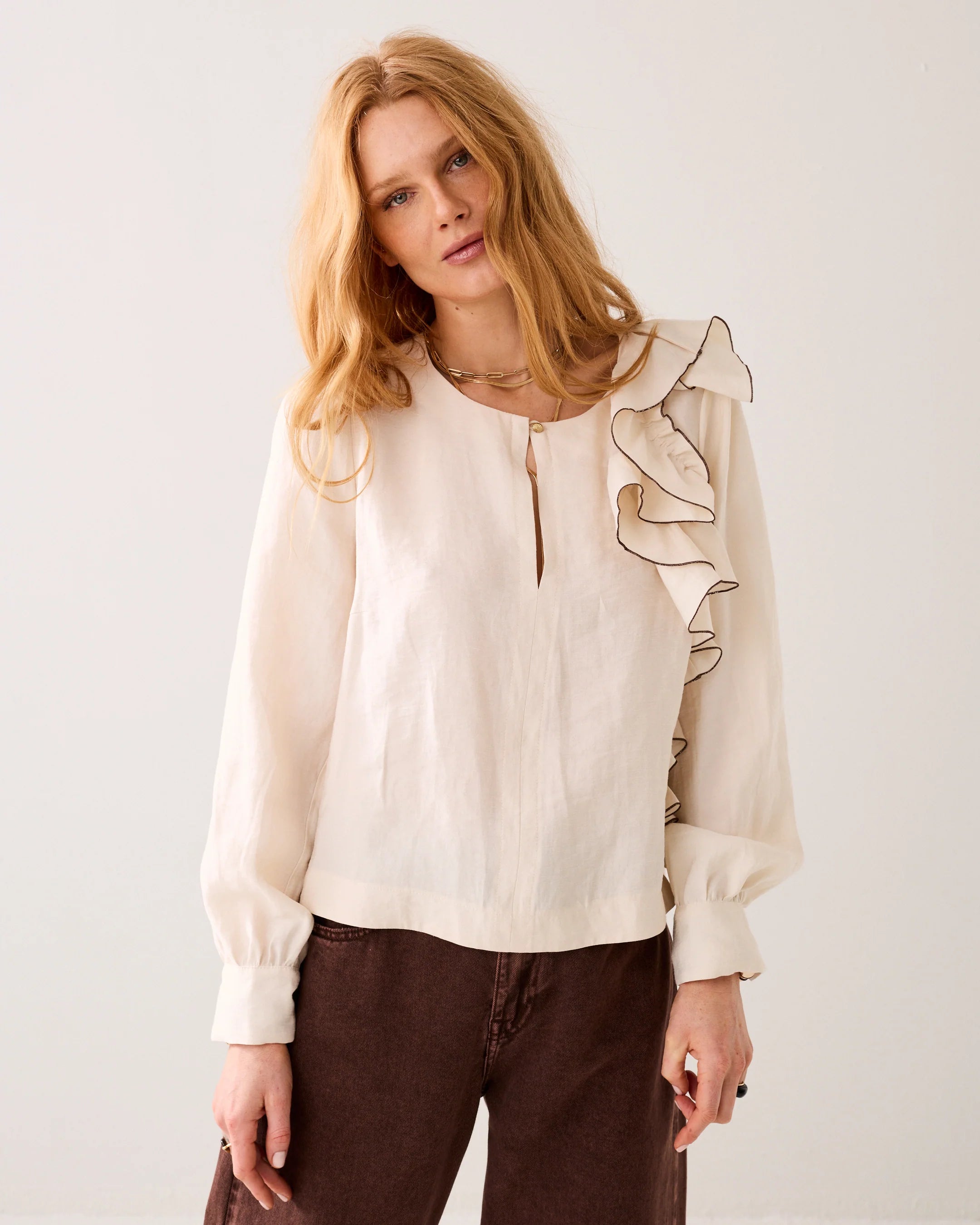 Summum asymmetric ruffle top styled with brown trousers