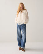 Summum cream sequin and bead blouse – full-length model view with jeans