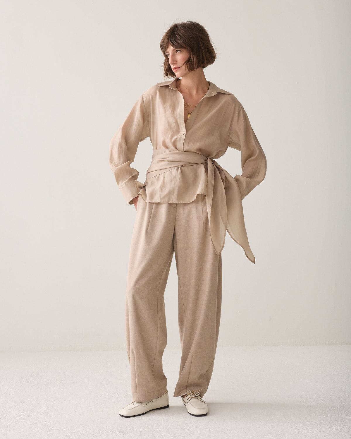 Women’s Summum sand wrap blouse styled with matching beige trousers