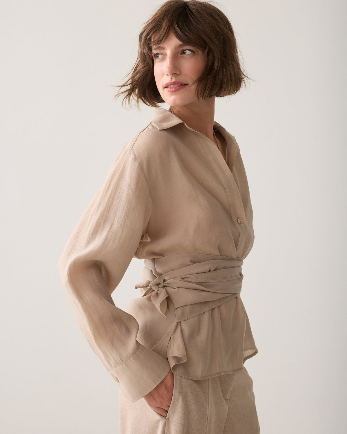 Side view of Summum sand wrap tie blouse