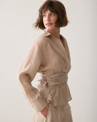 Side view of Summum sand wrap tie blouse