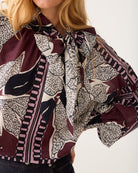 Close-up of Summum floral bow blouse neckline and print