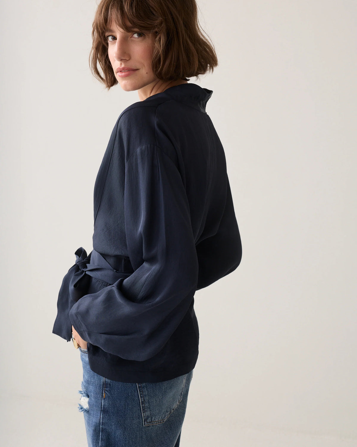  Summum navy V-neck top – side model view showing wide balloon sleeve