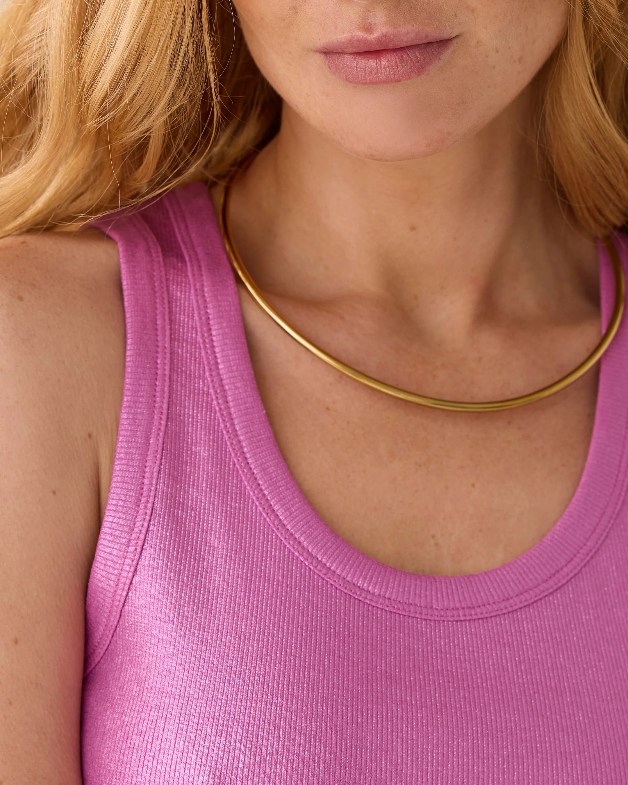 Close-up of Summum shiny pink tank top neckline and ribbed texture