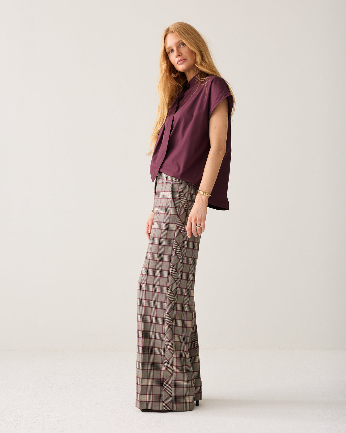 Summum check wide leg trousers side view with burgundy bow blouse