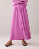 Close-up front view of Summum long pink Tencel skirt with soft sheen and gathered waistband