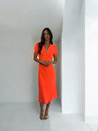 Girls Curiosity Tethys orange midi dress full length studio shot