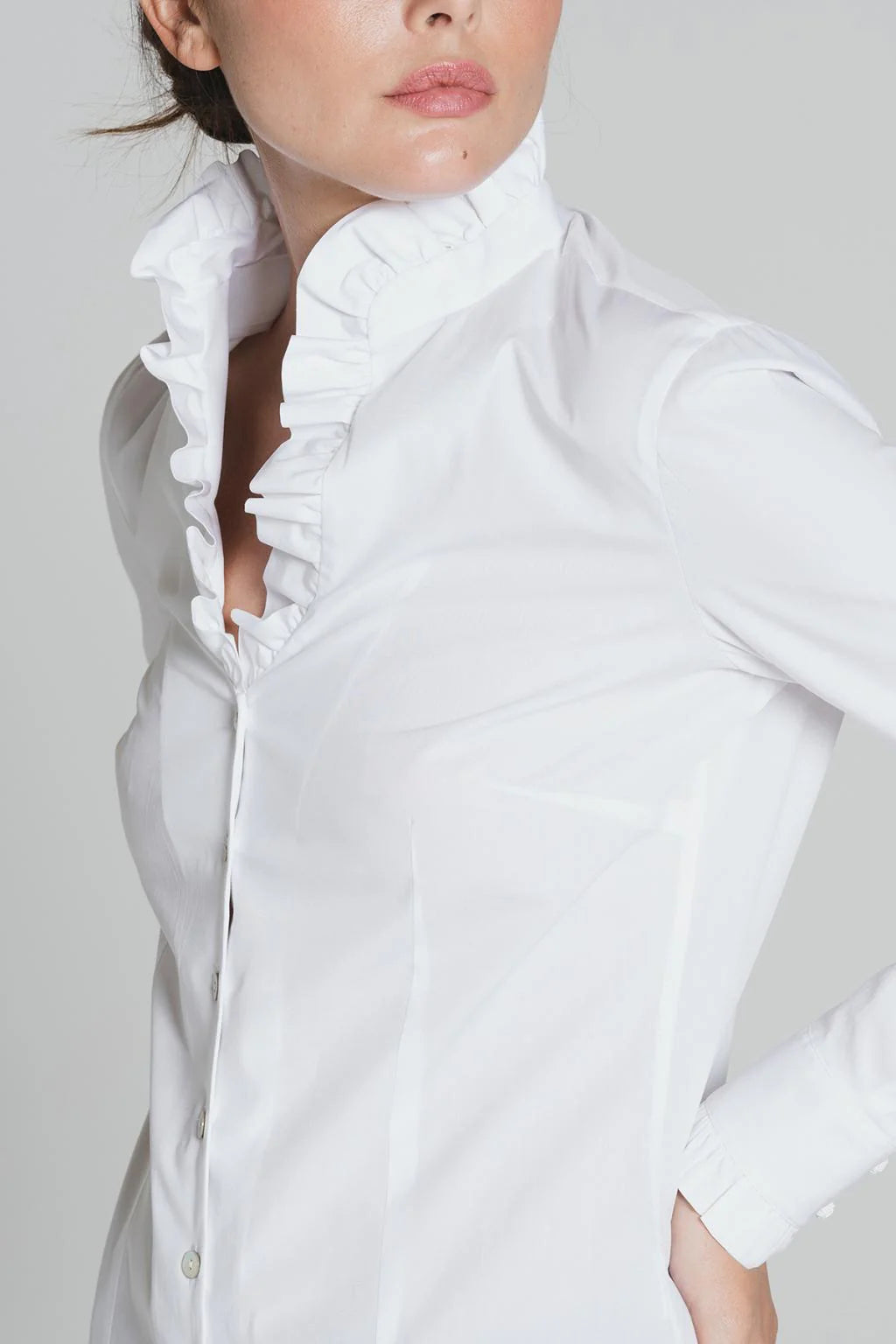 Side view of white Tinta Lucar shirt with ruffle collar detail