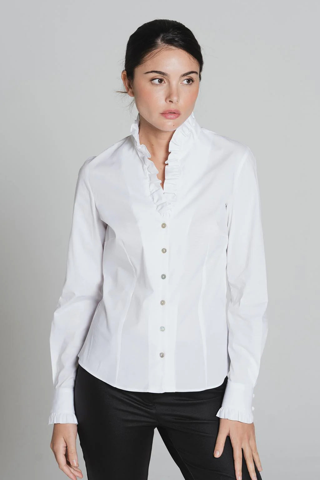 Model wearing white Tinta Lucar frill detail shirt with black trousers