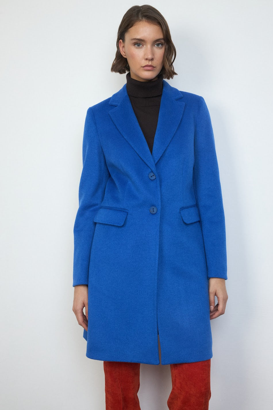 Front view of Tinta Rosa women’s long cobalt blue single-breasted coat with lapels.