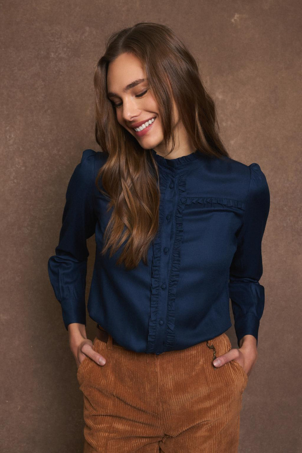 Tinta Victoria navy ruffle shirt styled with camel cord trousers