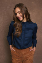 Tinta Victoria navy ruffle shirt styled with camel cord trousers