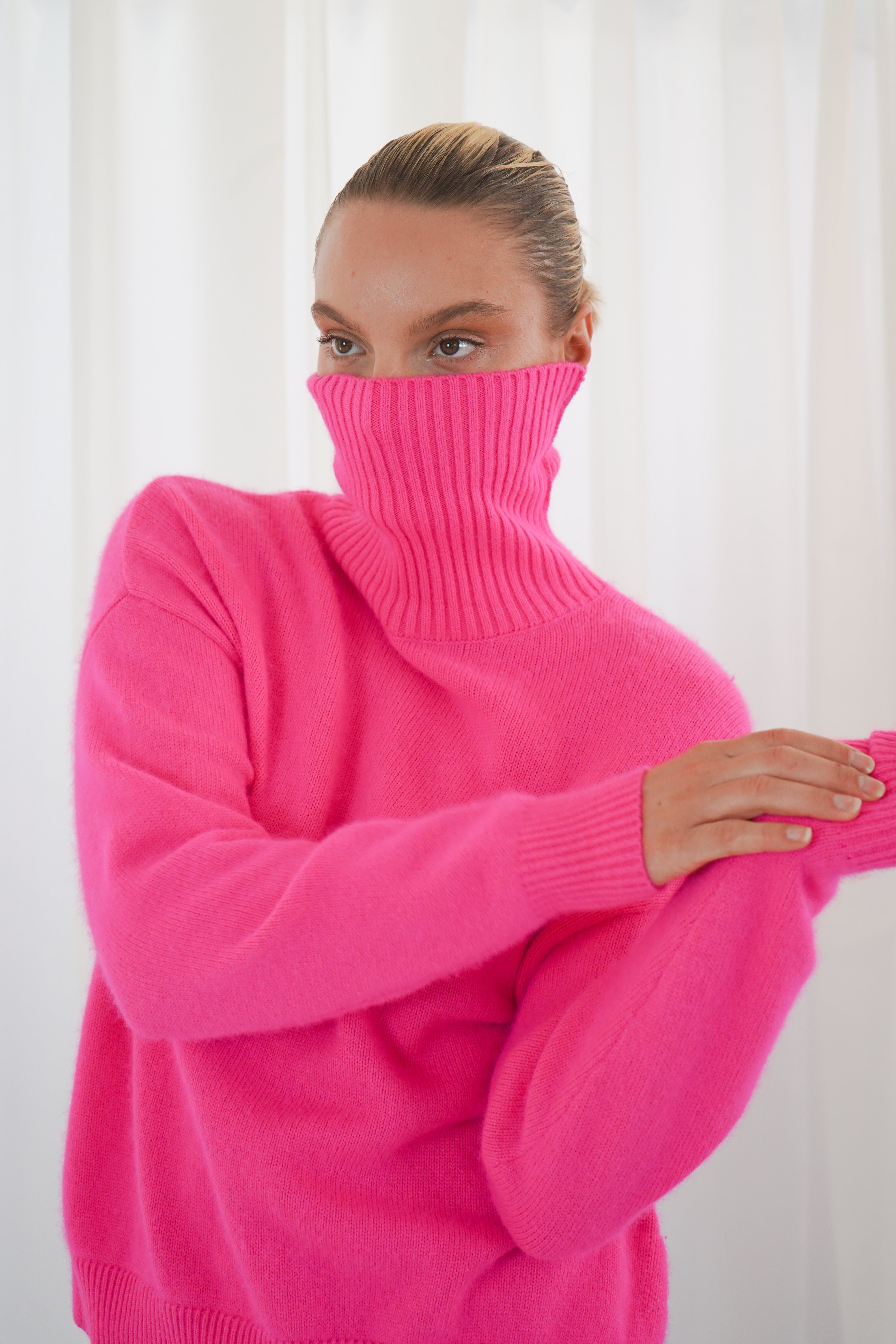 Twins Greeley neon pink soft knit roll neck jumper close-up