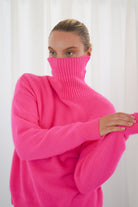 Twins Greeley neon pink soft knit roll neck jumper close-up