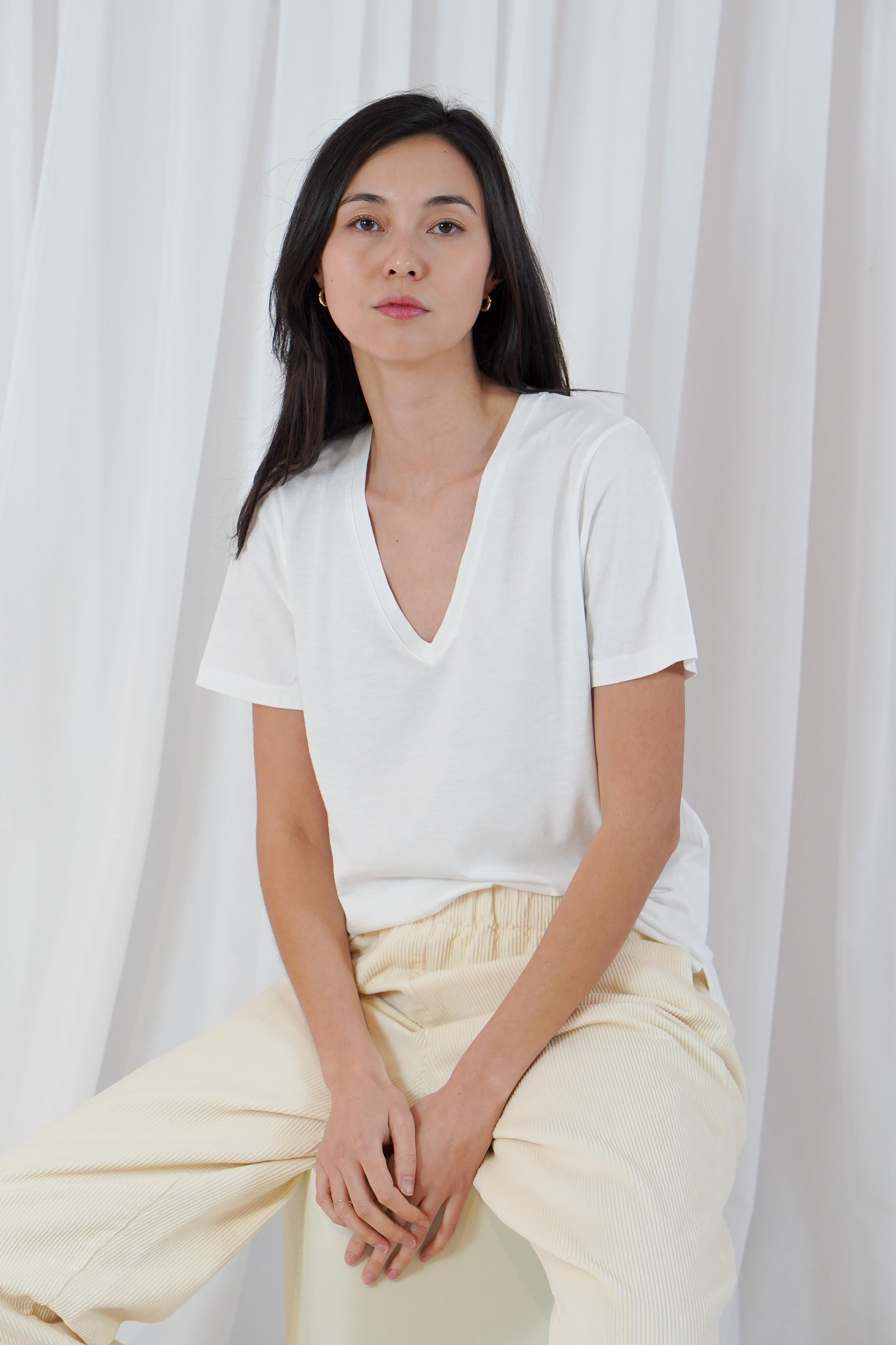 Twins Kings white cotton V-neck T-shirt styled with cream trousers