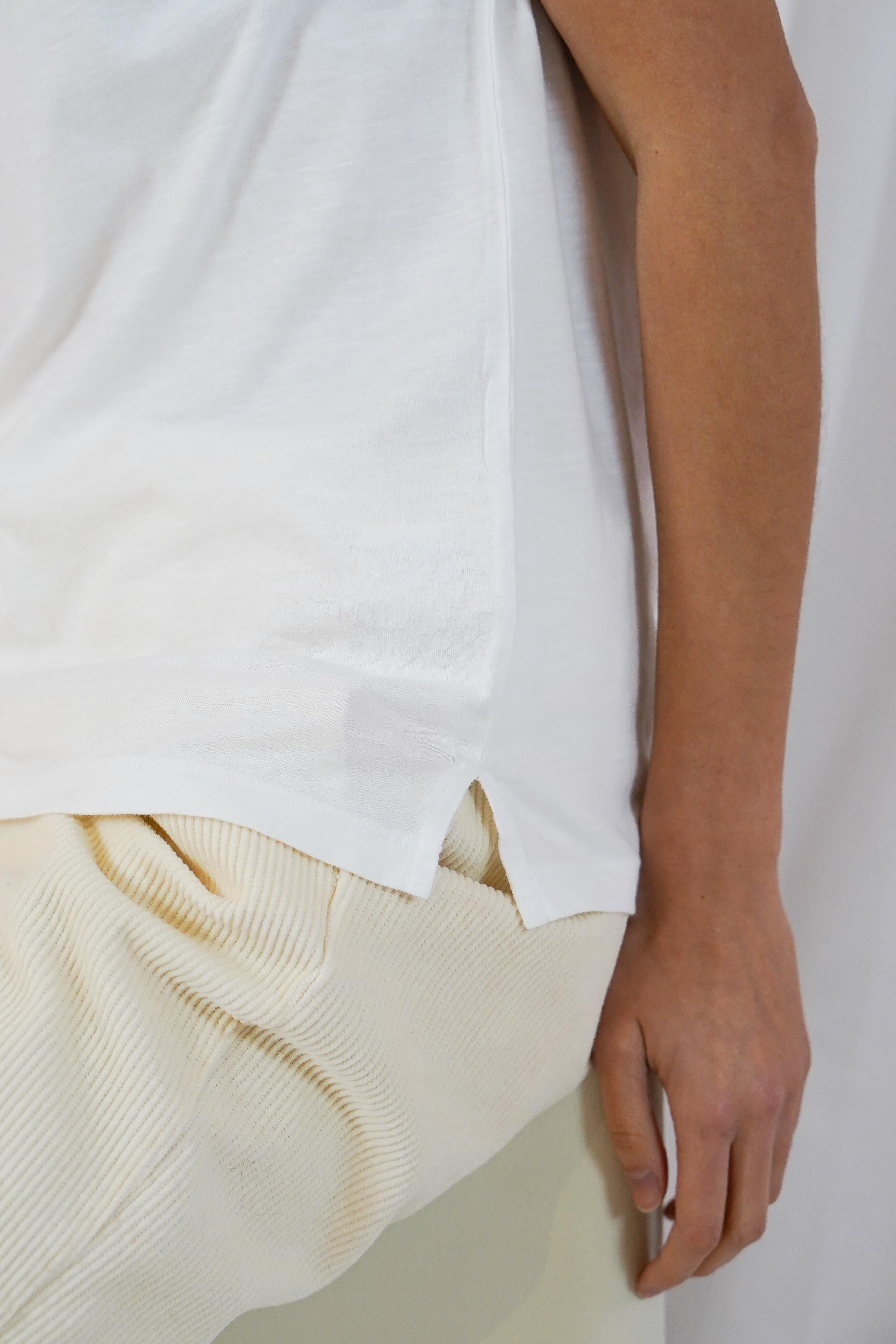 Side view of Twins Kings white V-neck T-shirt showing the relaxed hem