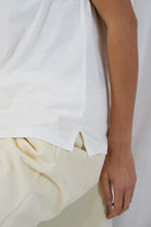 Side view of Twins Kings white V-neck T-shirt showing the relaxed hem