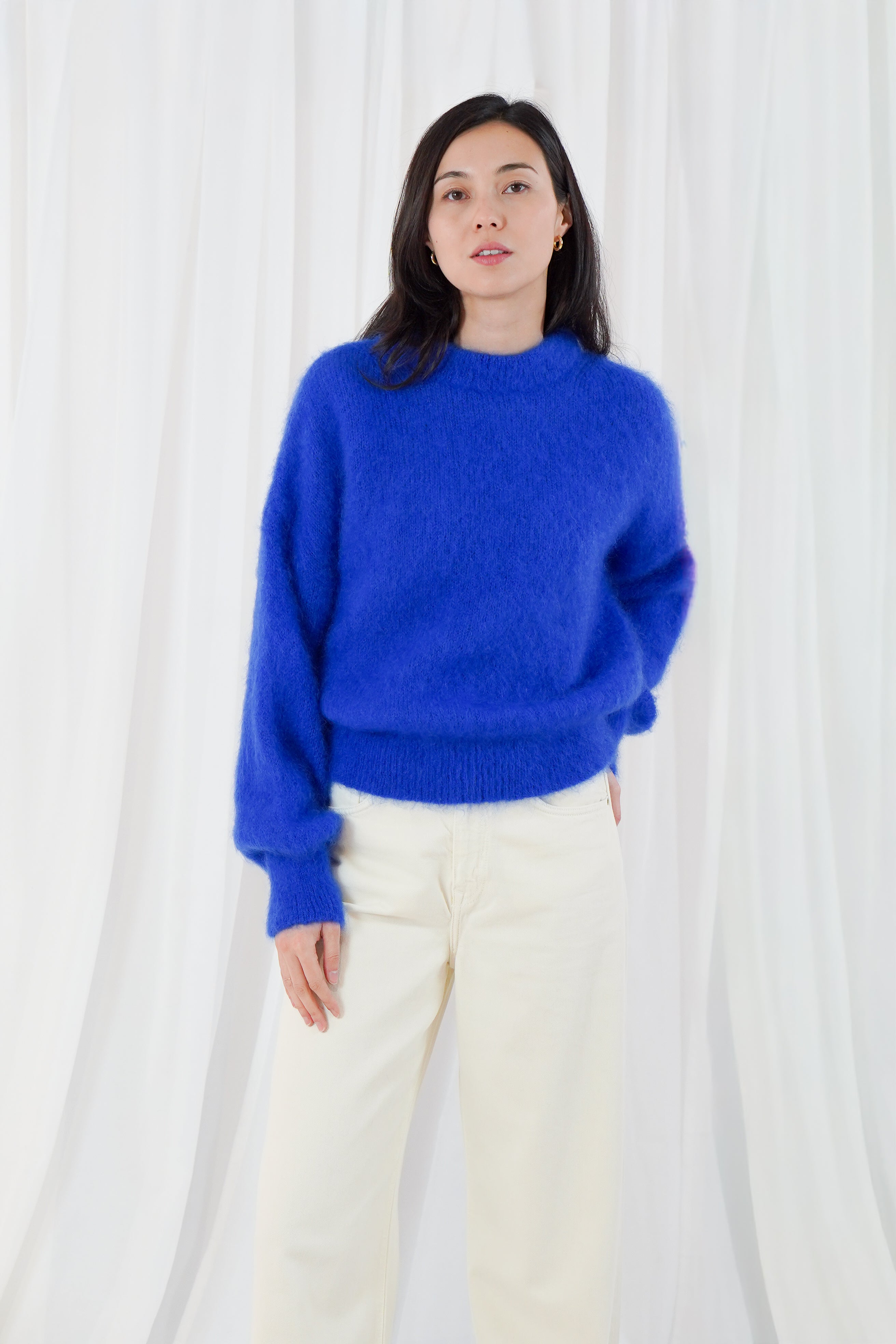 Twins Moana electric blue fluffy knit jumper styled with cream trousers