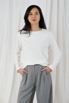  Twins Queens white fitted cotton long sleeve T-shirt styled with grey trousers