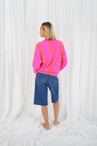Back view of Twins Reno neon pink and orange striped knitted jumper