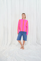 Twins Reno pink and orange striped jumper styled with denim shorts