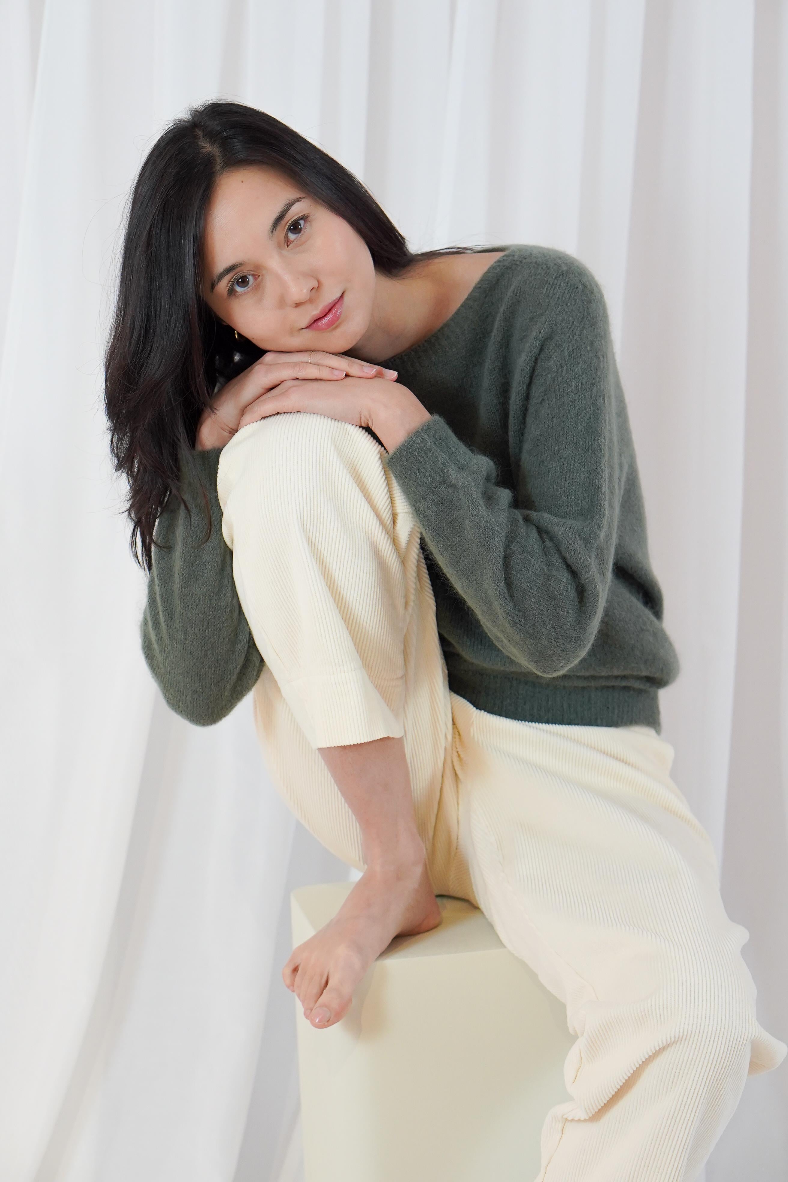 Twins Sanibel forest green alpaca blend jumper shown in a seated pose