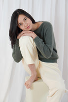 Twins Sanibel forest green alpaca blend jumper shown in a seated pose