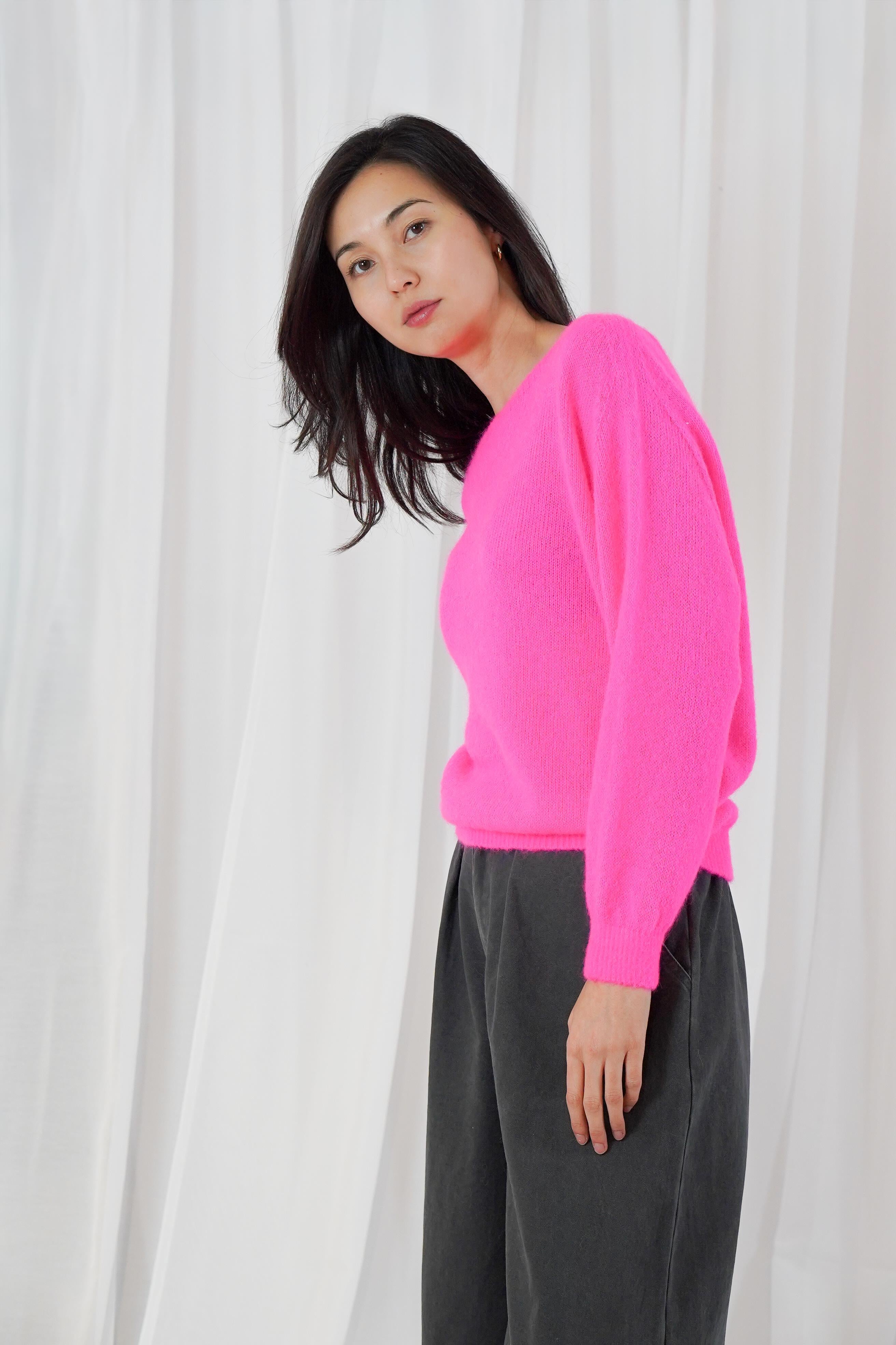 Twins Sanibel neon pink relaxed boat neck jumper worn with black trousers
