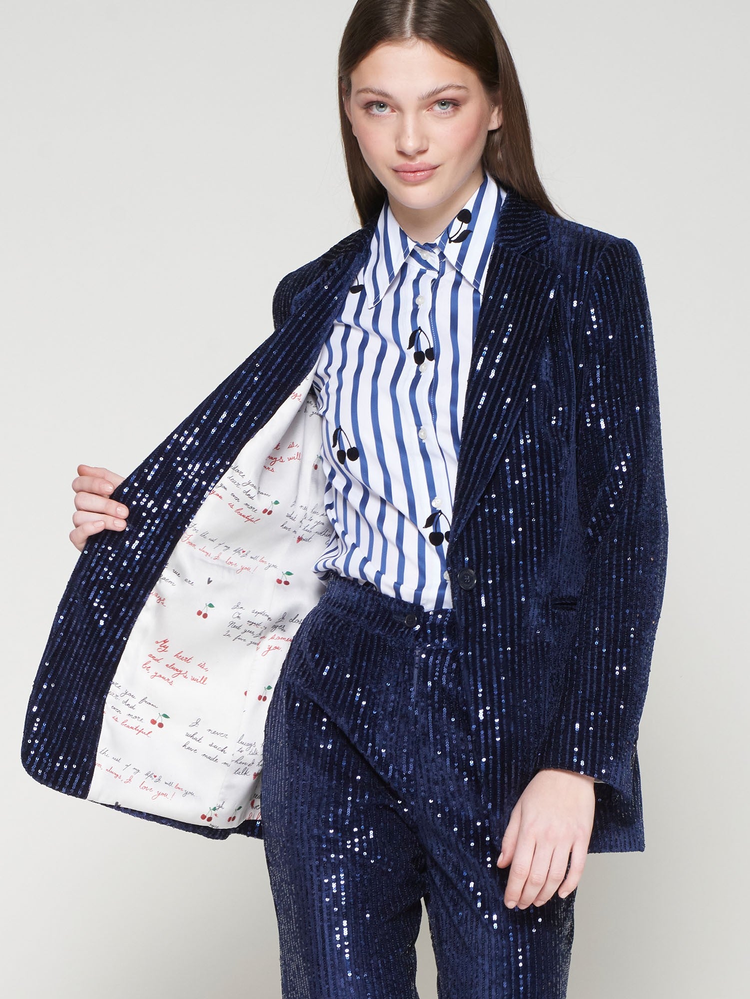 Shimmering navy velvet blazer by Vilagallo, styled with striped shirt