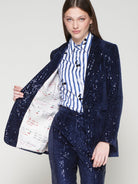 Shimmering navy velvet blazer by Vilagallo, styled with striped shirt