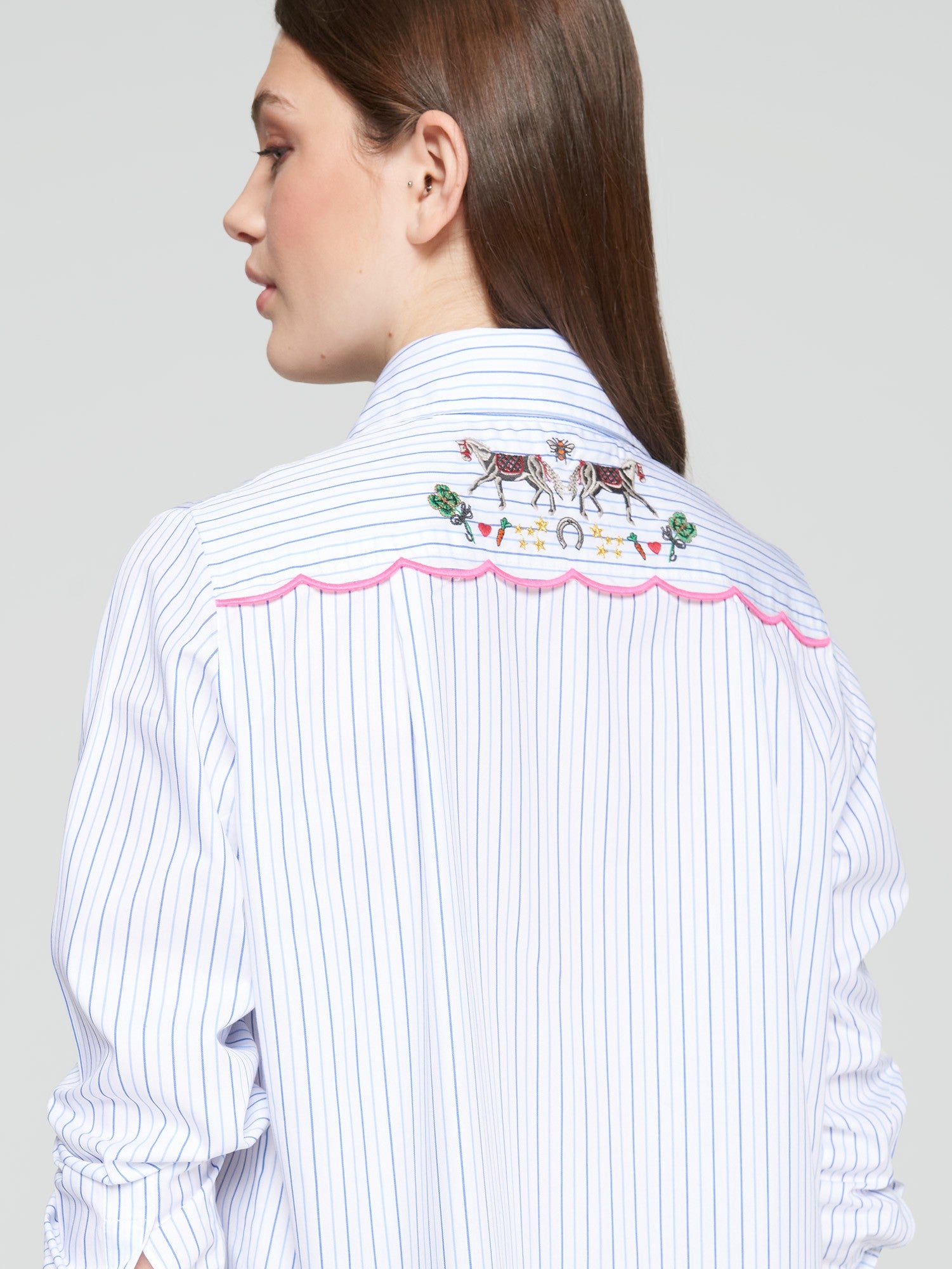 Close-up of equestrian embroidery on Vilagallo striped cotton shirt