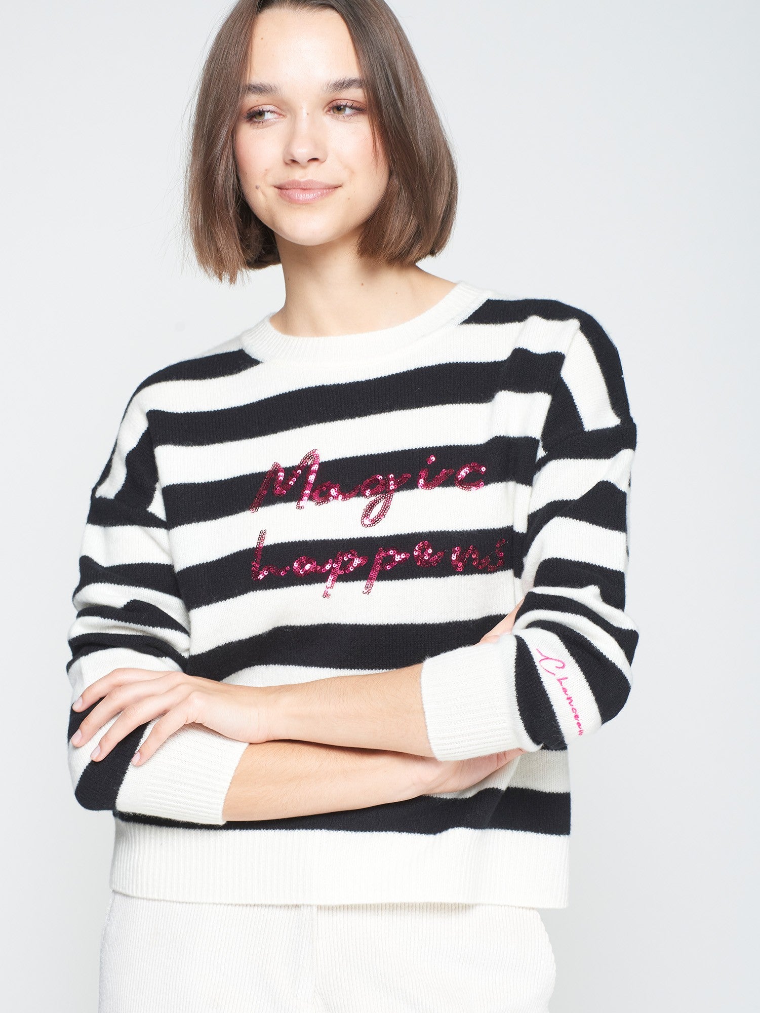 Model wearing Vilagallo wool jumper with black and white stripes