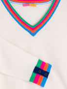 Viagallo Women’s cream wool jumper with colourful stripes and button cuff detail.