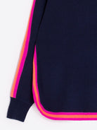 Close-up of neon stripe trim on Vilagallo navy wool-blend jumper.