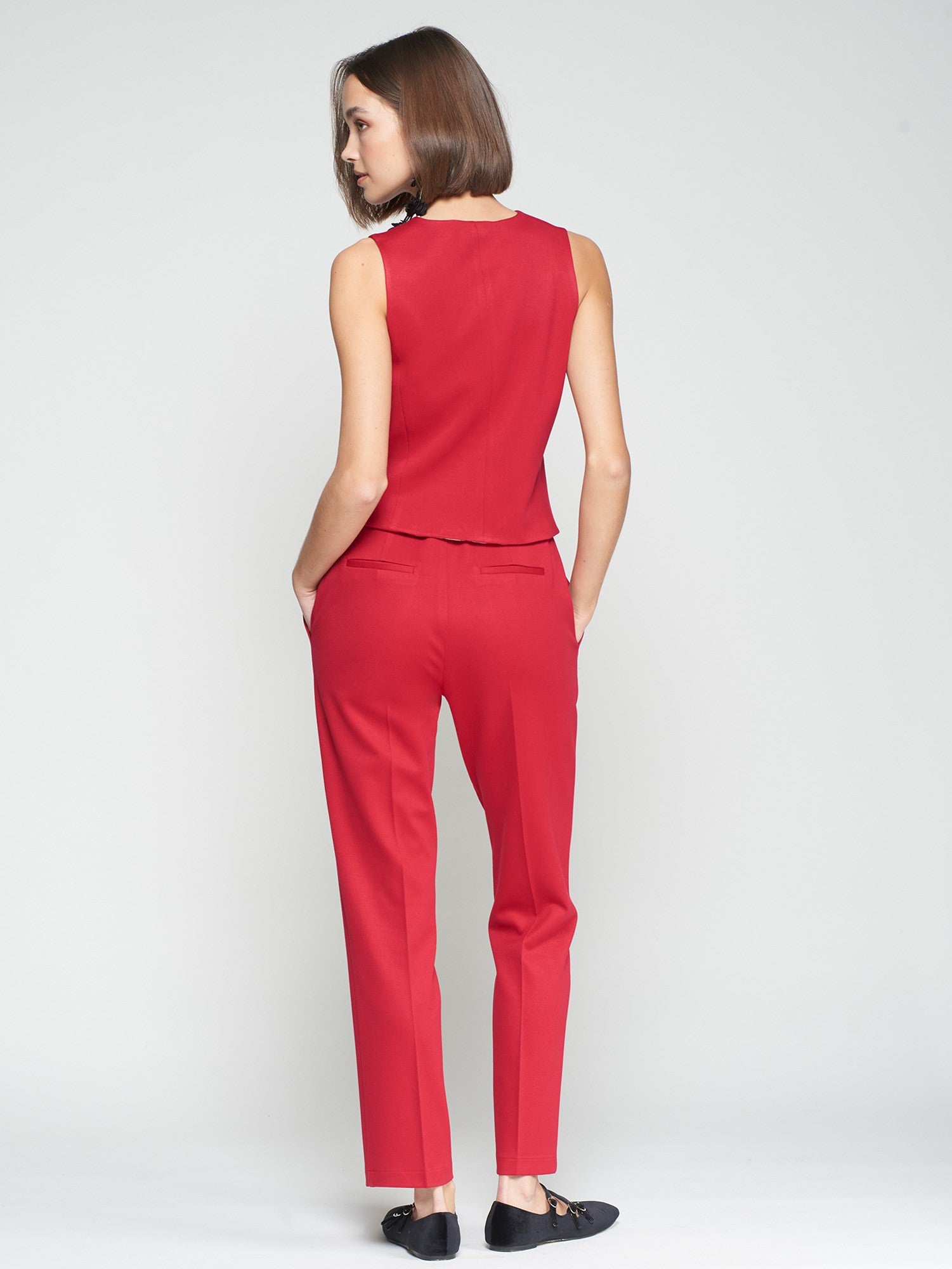 Back view of Vilagallo red straight leg trousers with welt pockets