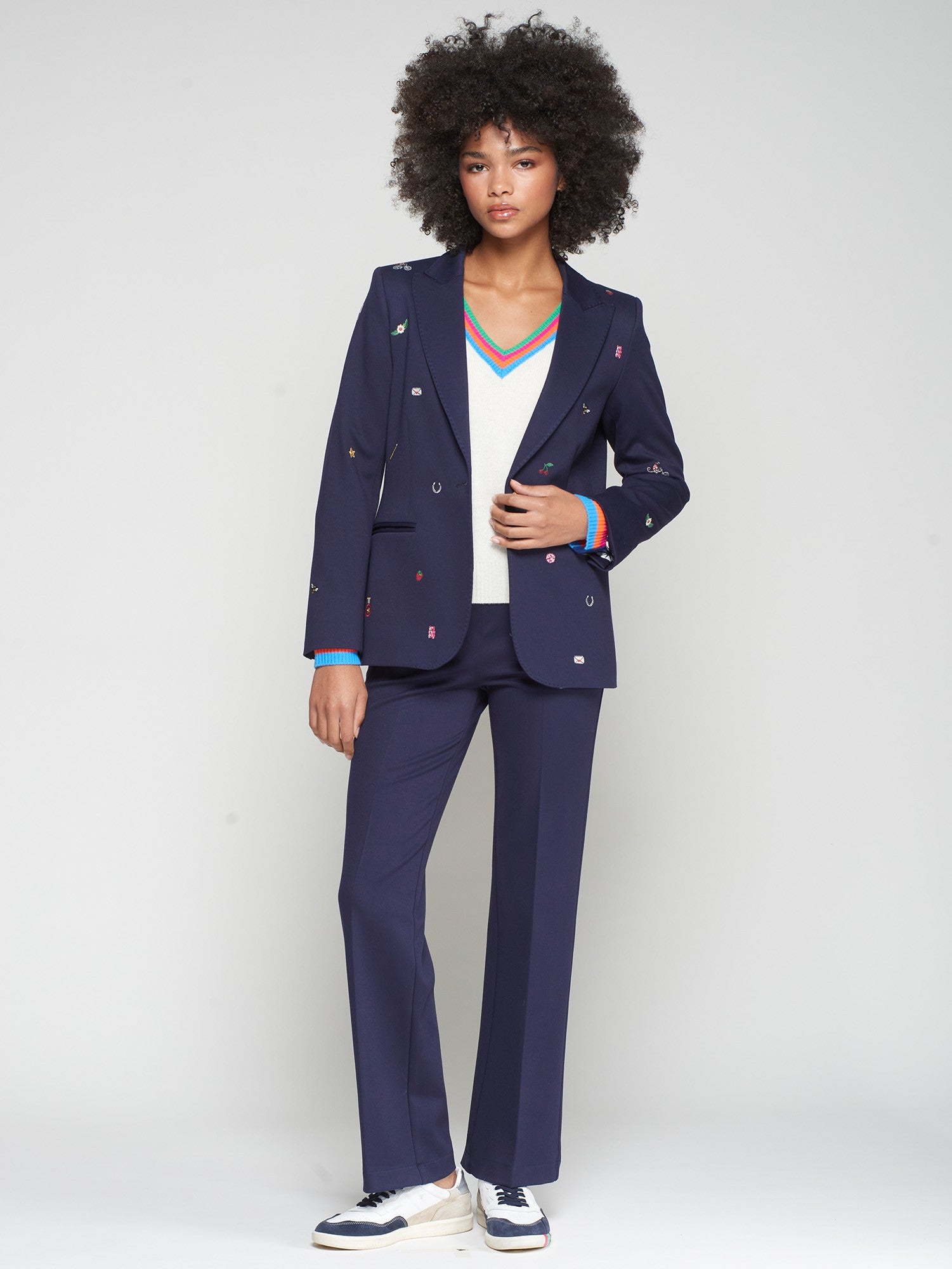 Vilagallo Matching navy blazer and straight-leg trousers styled with trainers.