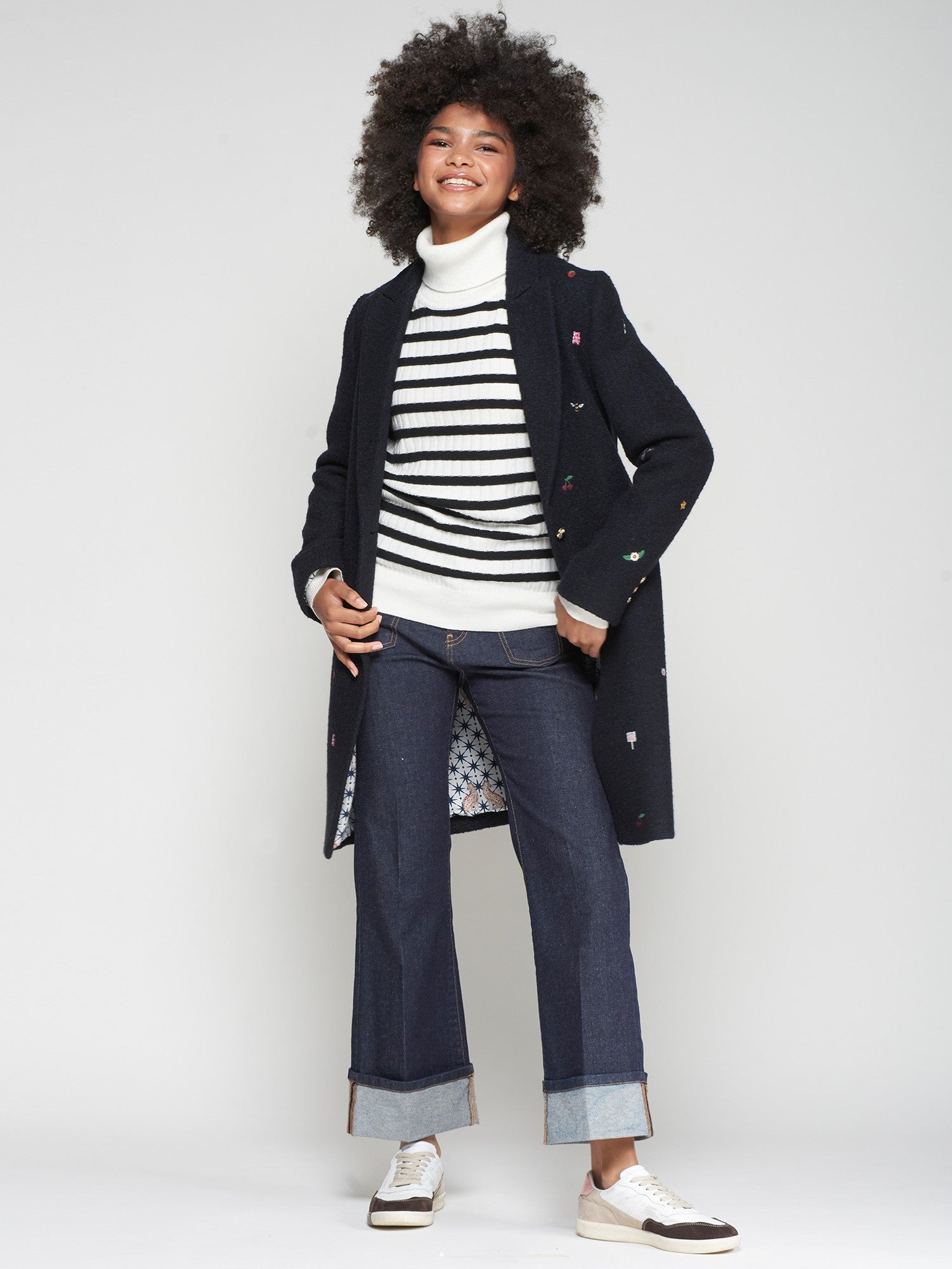 Women’s navy longline wool coat with subtle embroidery detail.