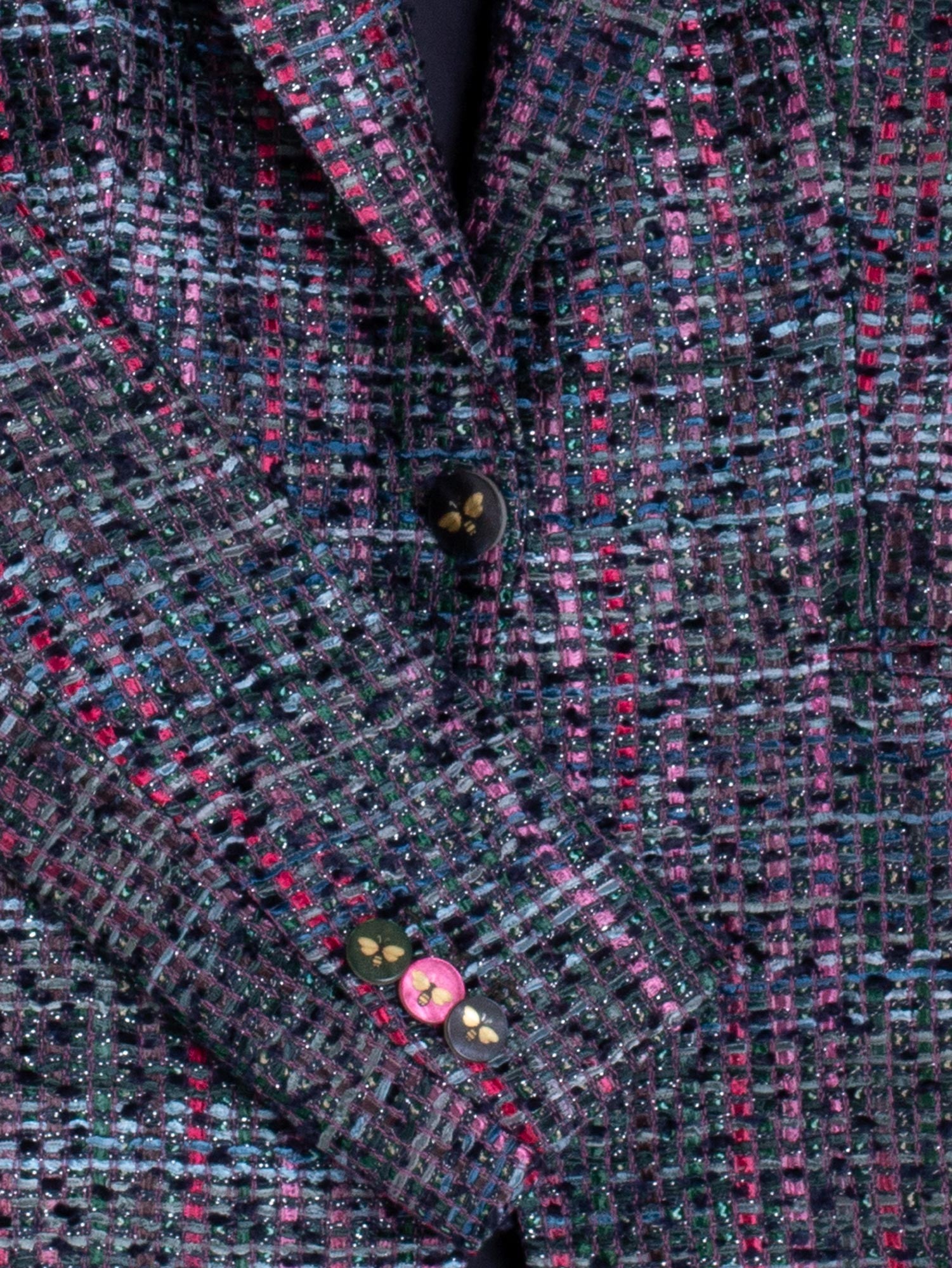 Close-up of Vilagallo bee buttons on the cuff of the Sophia tweed women’s blazer